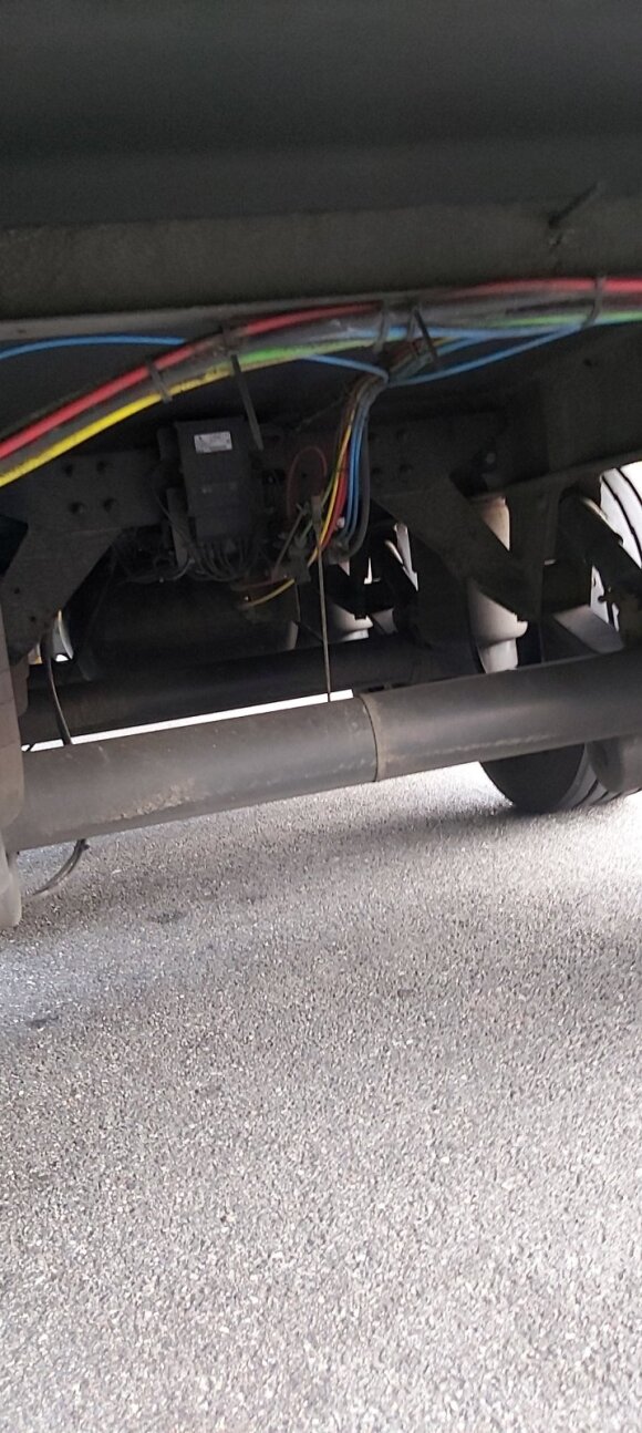 Sitting on the axles of a trailer, they try to get on the ferry illegally.