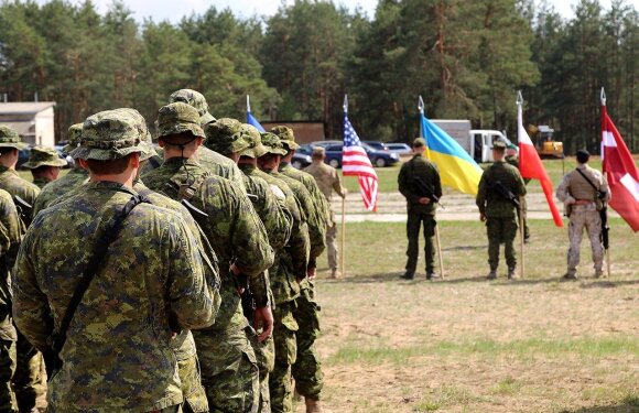 Canadian soldiers listen to remarks during the opening ceremony of Exercise HUNTER Photo Captain Mark Ruban Public Affairs Officer Operation REASSURANCE Land Task Force