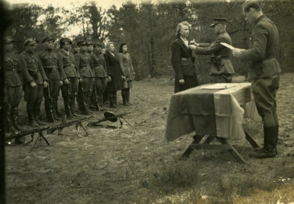 Dainavos apygardos Kazimieraičio rinktinės partizanų apdovanojimo iškilmės. Įsakymą skaito Lionginas Baliukevičius-Dzūkas; Sofijai Budėnaitei-Ramunei apdovanojimą sega Adolfas Ramanauskas-Vanagas. 1948 m.